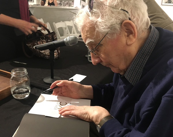 Ted Russell signing books at the panel discussion.