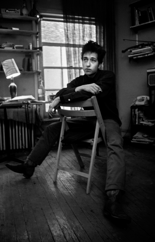 Sitting on his chair. 161 W 4th St. 1964.