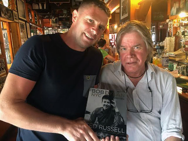 Chris Murray presenting Tómas Ó Sé with a copy of Ted Russell's Bob Dylan NYC 1961-1964. © Carlotta Hester/Govinda Gallery Archive.